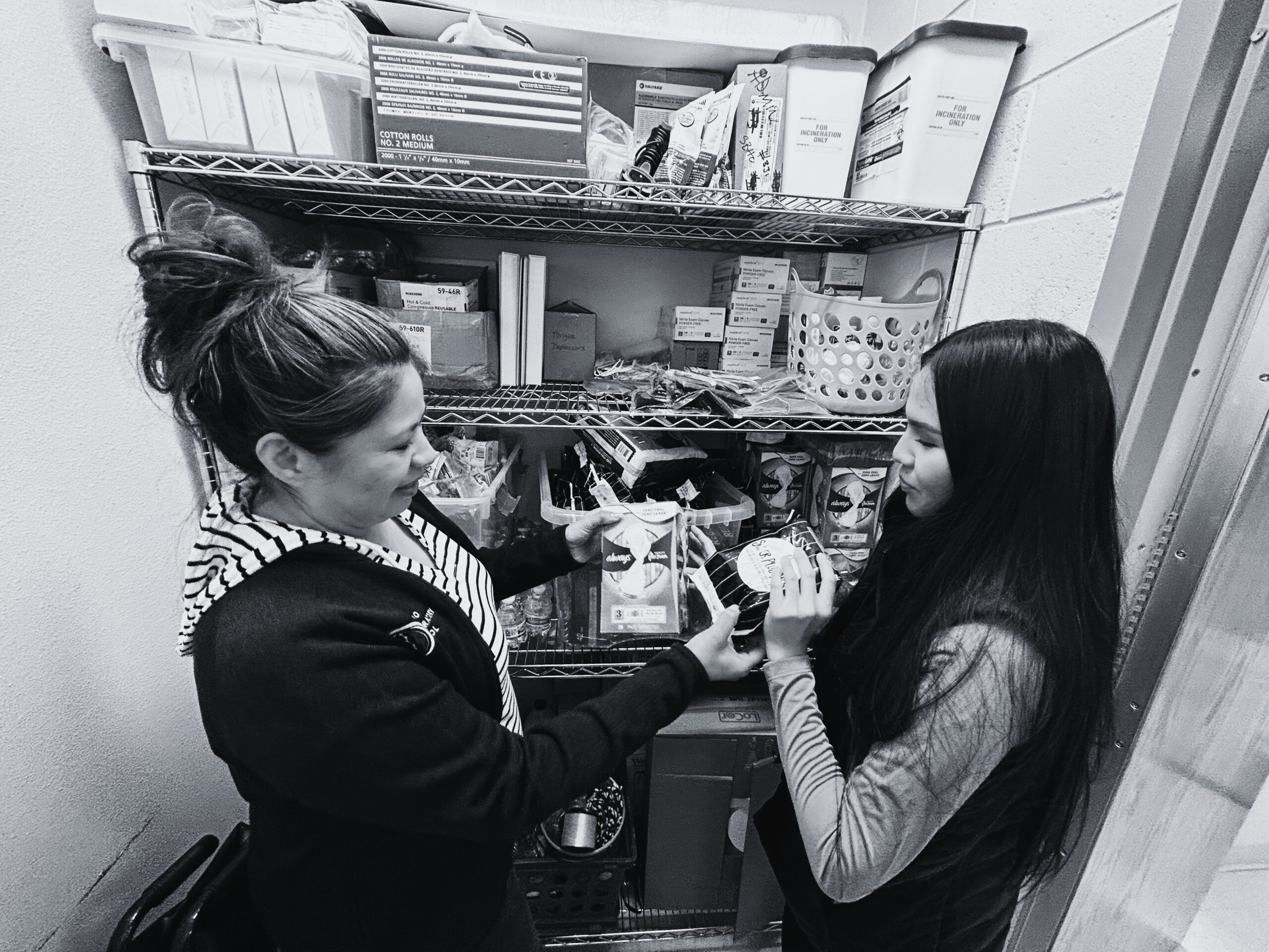 SFIS students help refill a campus bathroom with period products.